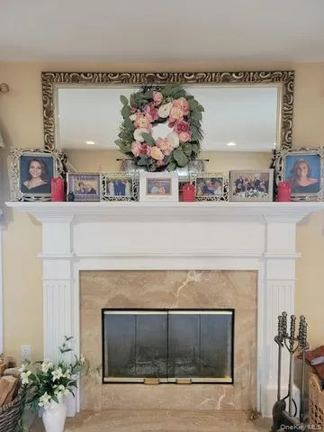 a front view of a fireplace with painting on it