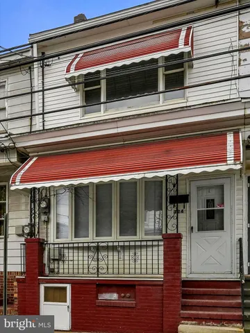 a view of empty room with wooden floor and fireplace