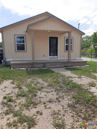 a house that has a big yard in front of it