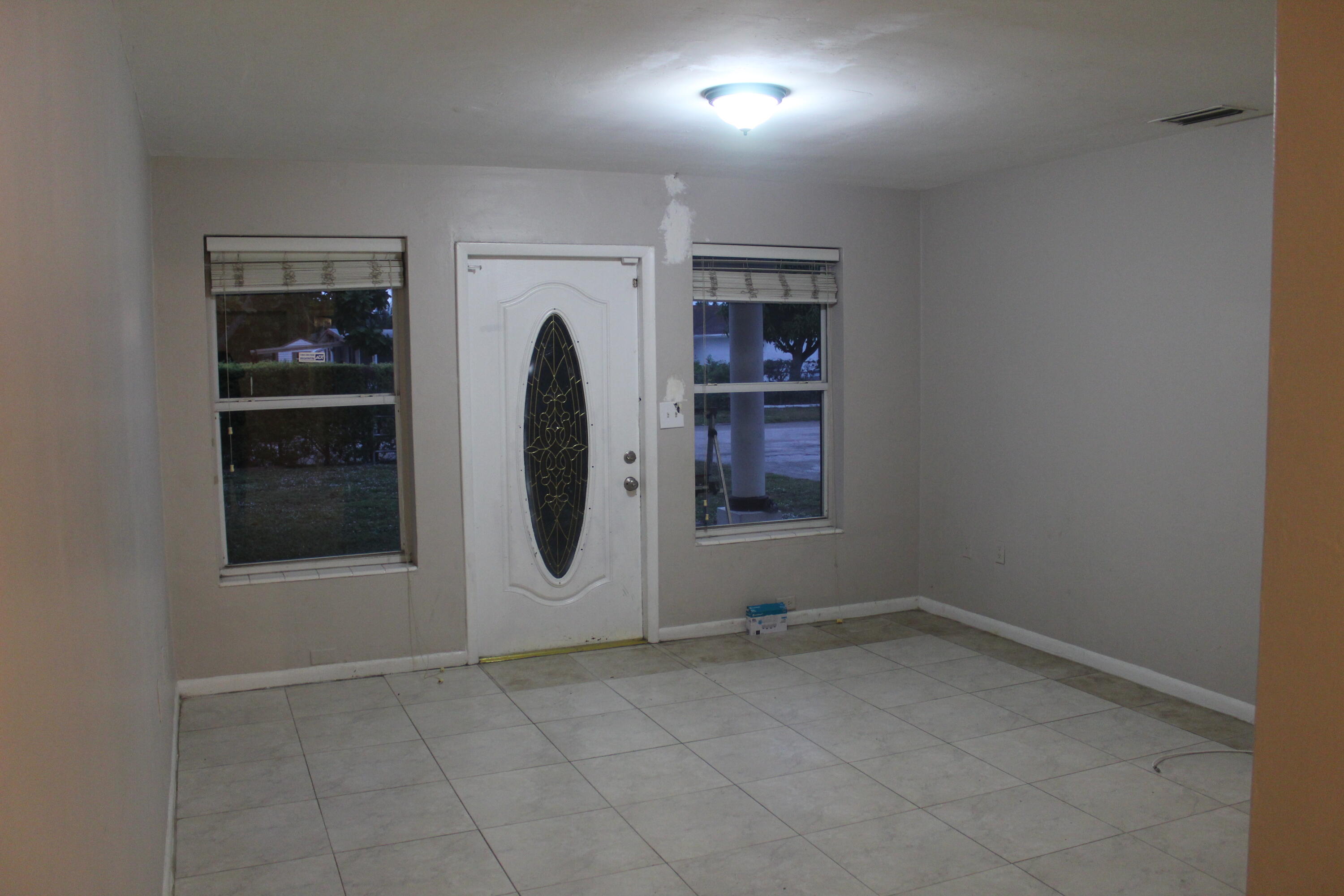 4434 Venus Avenue, Unit A West Palm Beach, FL 33406 - Photo 4 of 9 an empty room with windows