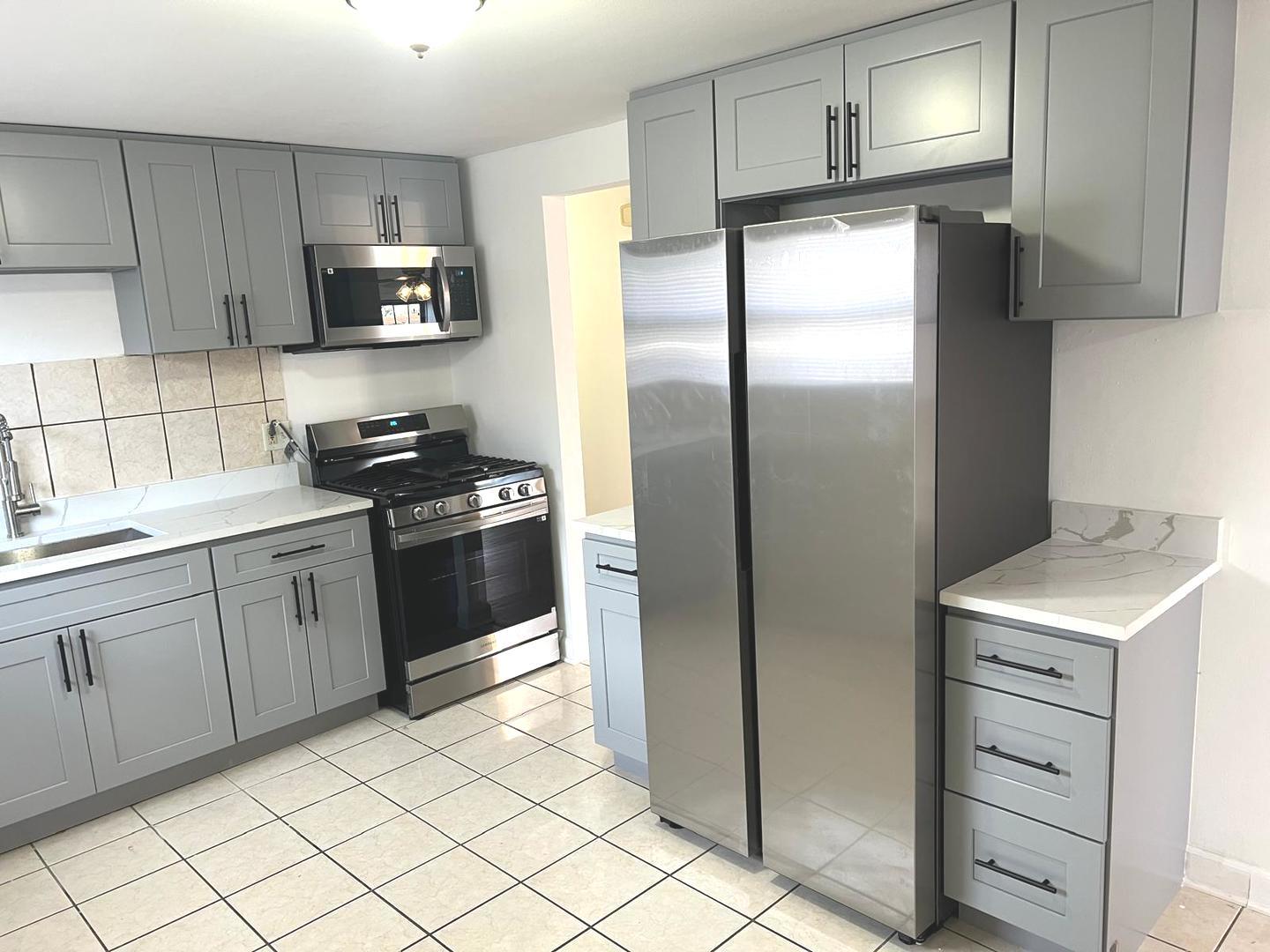 3101 Emery Lane Robbins, IL 60472 - Photo 11 of 22 a kitchen with a refrigerator sink and cabinets