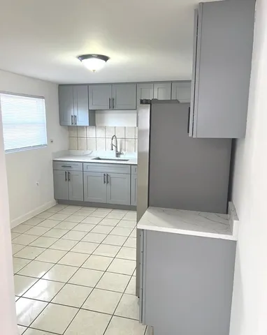 a kitchen with cabinets and white appliances