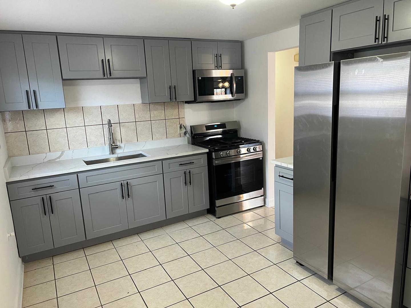 3101 Emery Lane Robbins, IL 60472 - Photo 13 of 22 a kitchen with a refrigerator sink and cabinets