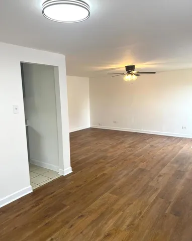an empty room with wooden floor