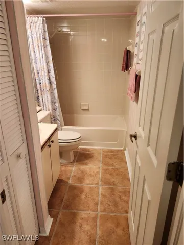 a bathroom with a glass door shower and a toilet