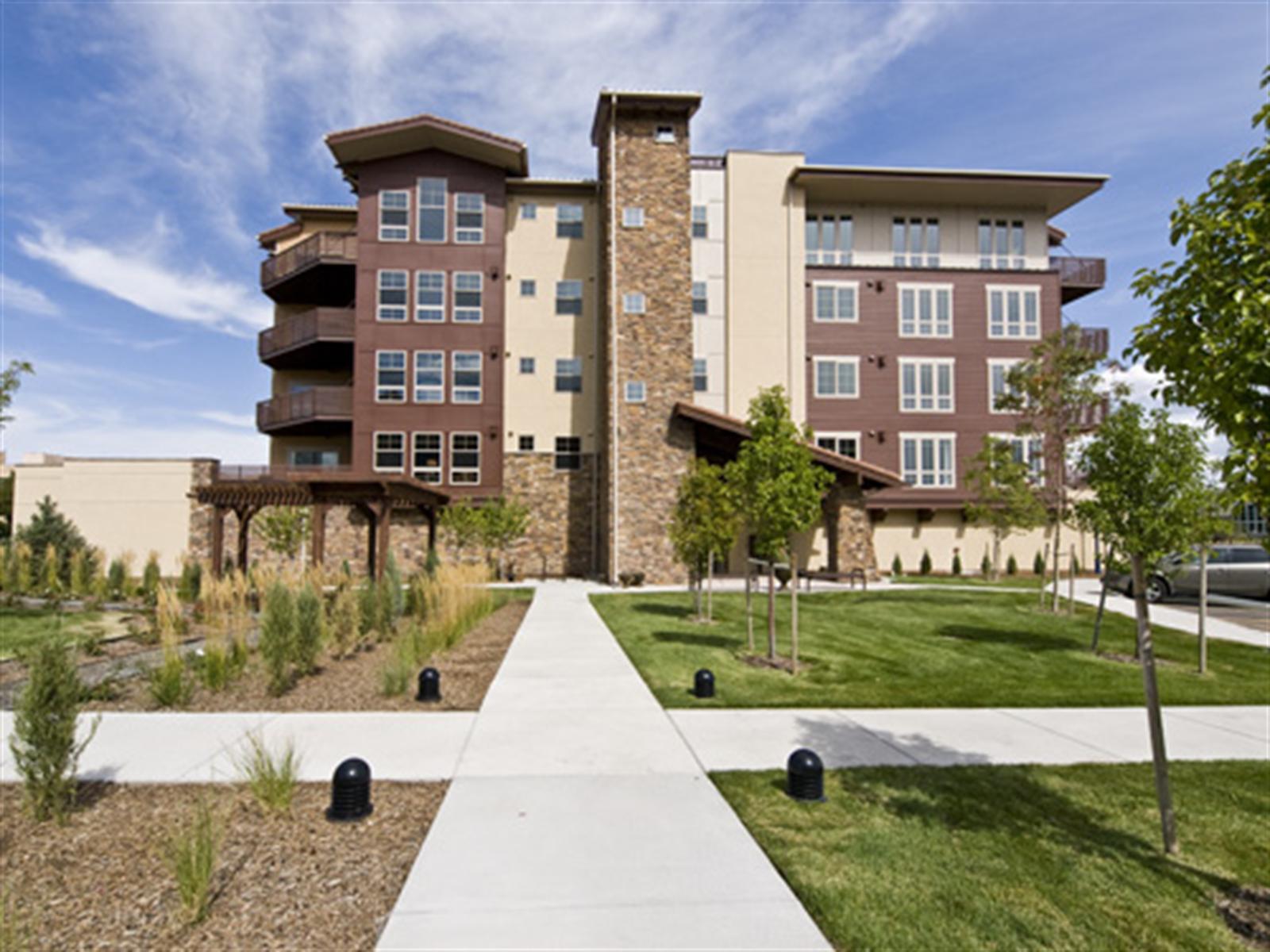 85 Rampart Way, Unit 409 Denver, CO 80230 - Photo 1 of 1 a view of a building with a yard