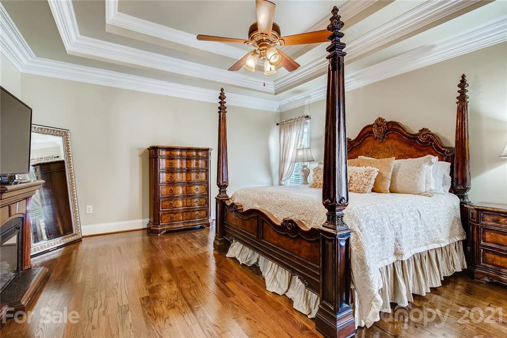 6671 Fox Ridge Circle Davidson, NC 28036 - Photo 14 of 26 a bedroom with a bed and a flat tv screen on the dresser