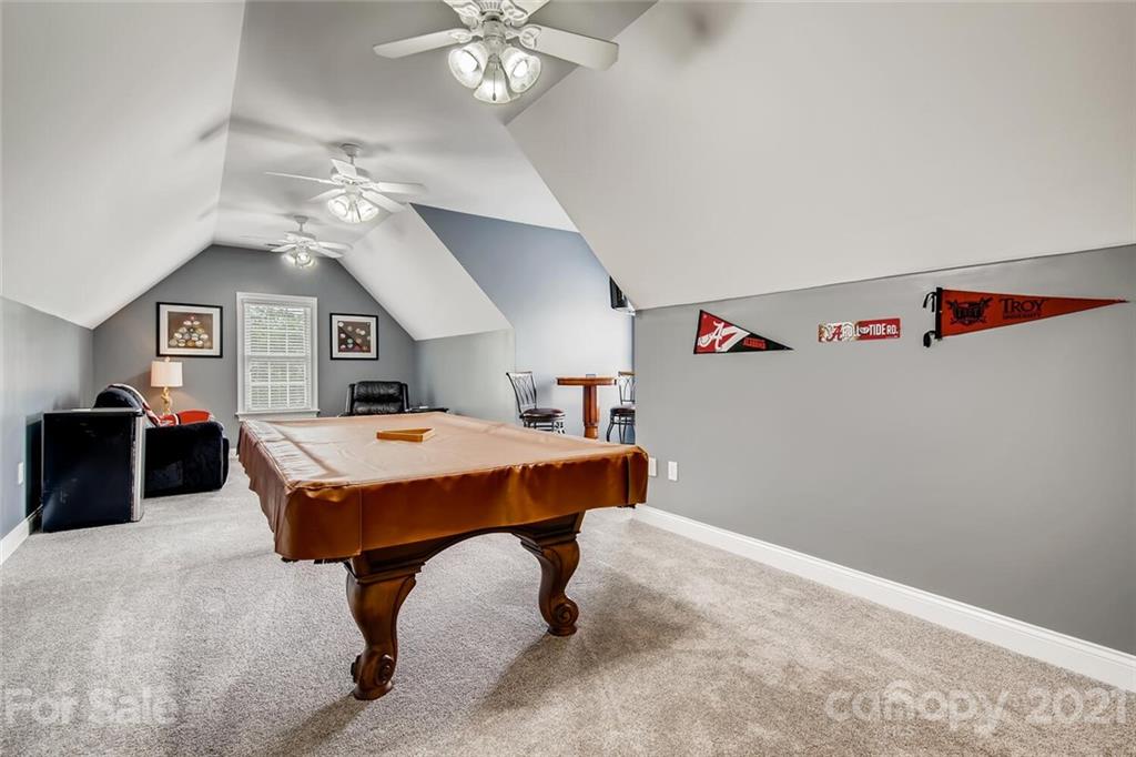 6671 Fox Ridge Circle Davidson, NC 28036 - Photo 22 of 26 a living room with a table and chairs