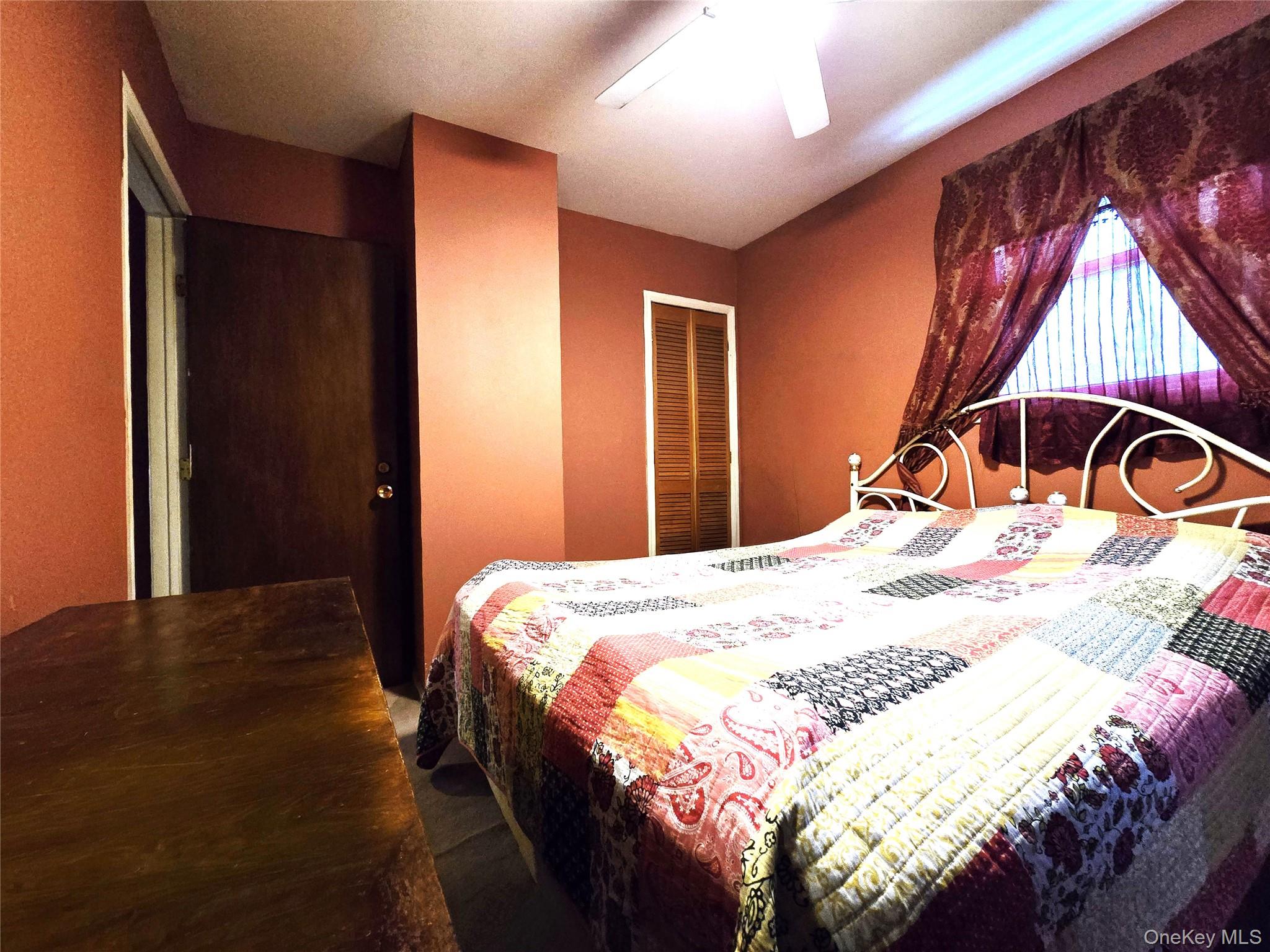 97 Hawkins Street Bronx, NY 10464 - Photo 17 of 20 a bedroom with a bed and a window