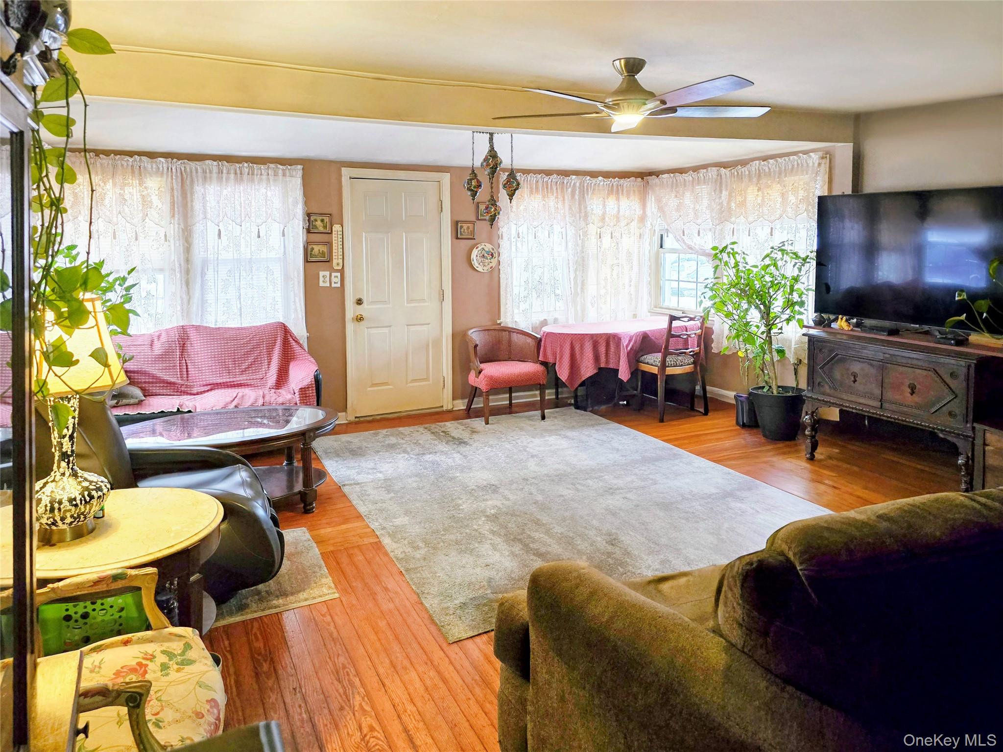 97 Hawkins Street Bronx, NY 10464 - Photo 3 of 20 a living room filled with furniture chandelier and a window
