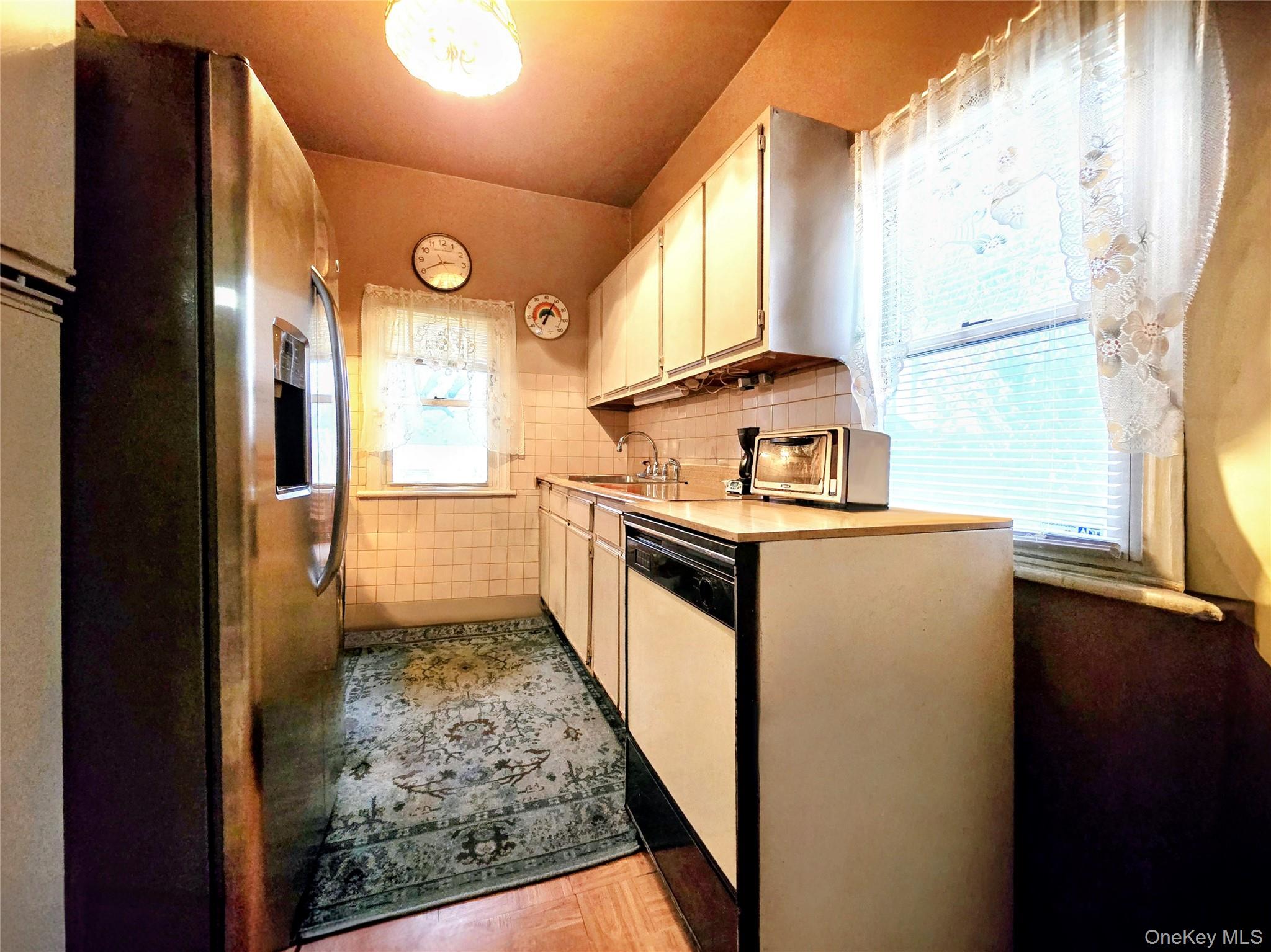 97 Hawkins Street Bronx, NY 10464 - Photo 10 of 20 a kitchen with stainless steel appliances granite countertop a stove a sink and a refrigerator