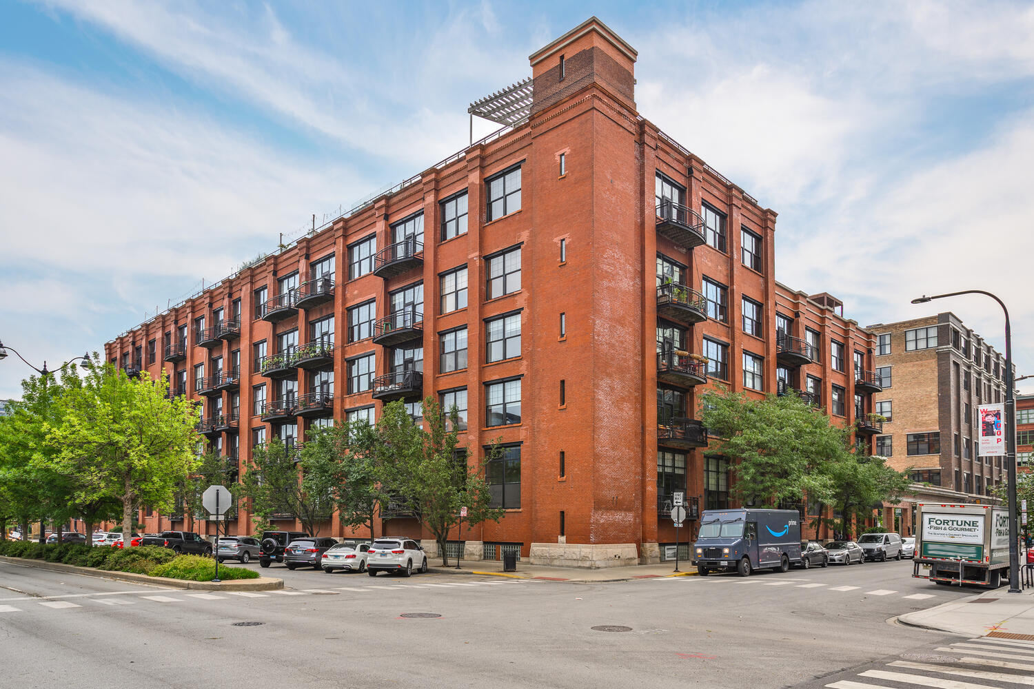 a view of a tall building next to a road