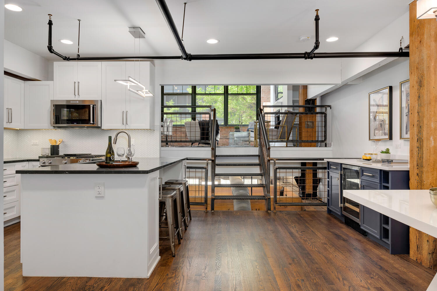 1000 West Washington Boulevard, Unit 148 Chicago, IL 60607 - Photo 2 of 29 a kitchen with stainless steel appliances granite countertop a sink a stove and a wooden floors