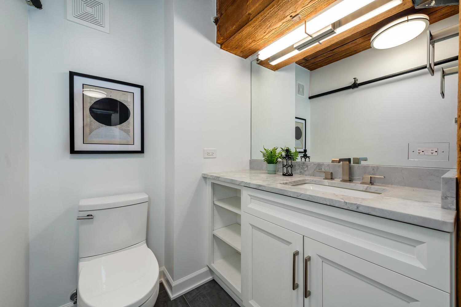 1000 West Washington Boulevard, Unit 148 Chicago, IL 60607 - Photo 17 of 29 a bathroom with a toilet sink and mirror