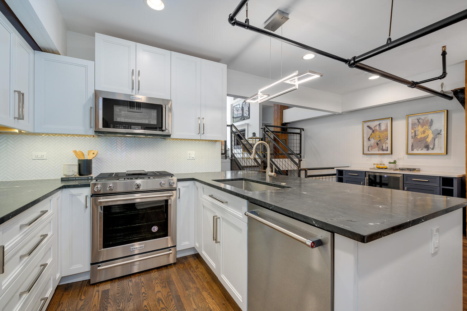 1000 West Washington Boulevard, Unit 148 Chicago, IL 60607 - Photo 6 of 29 a kitchen with stainless steel appliances granite countertop a sink stove and microwave