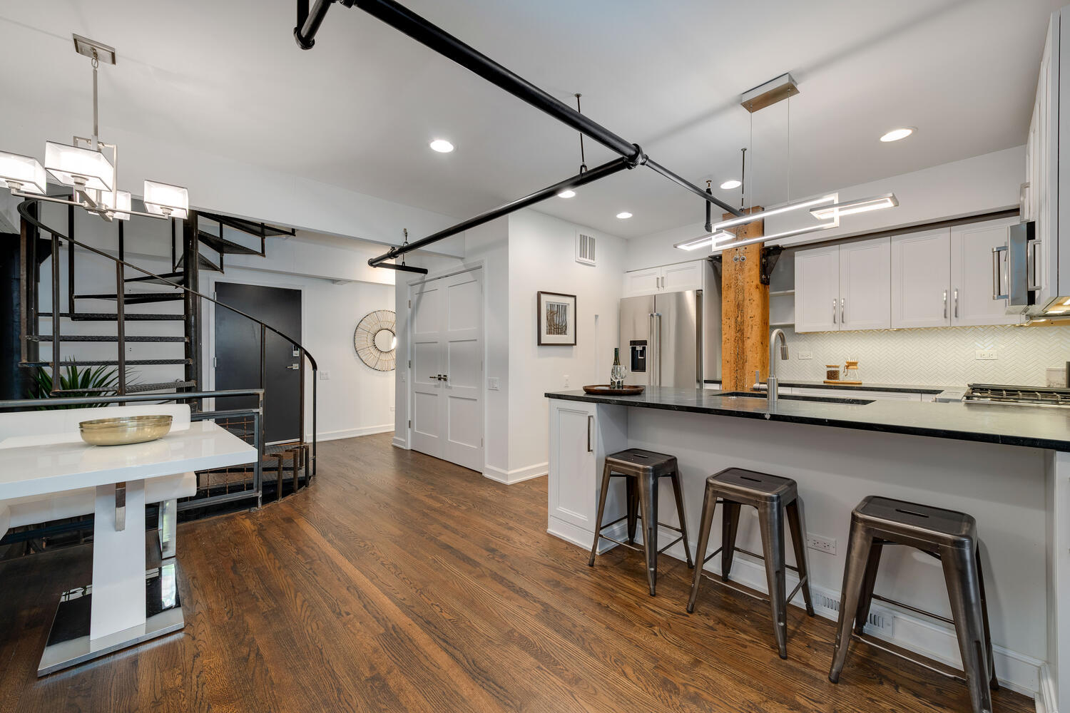 1000 West Washington Boulevard, Unit 148 Chicago, IL 60607 - Photo 7 of 29 a kitchen with granite countertop a table chairs stove a sink and a refrigerator