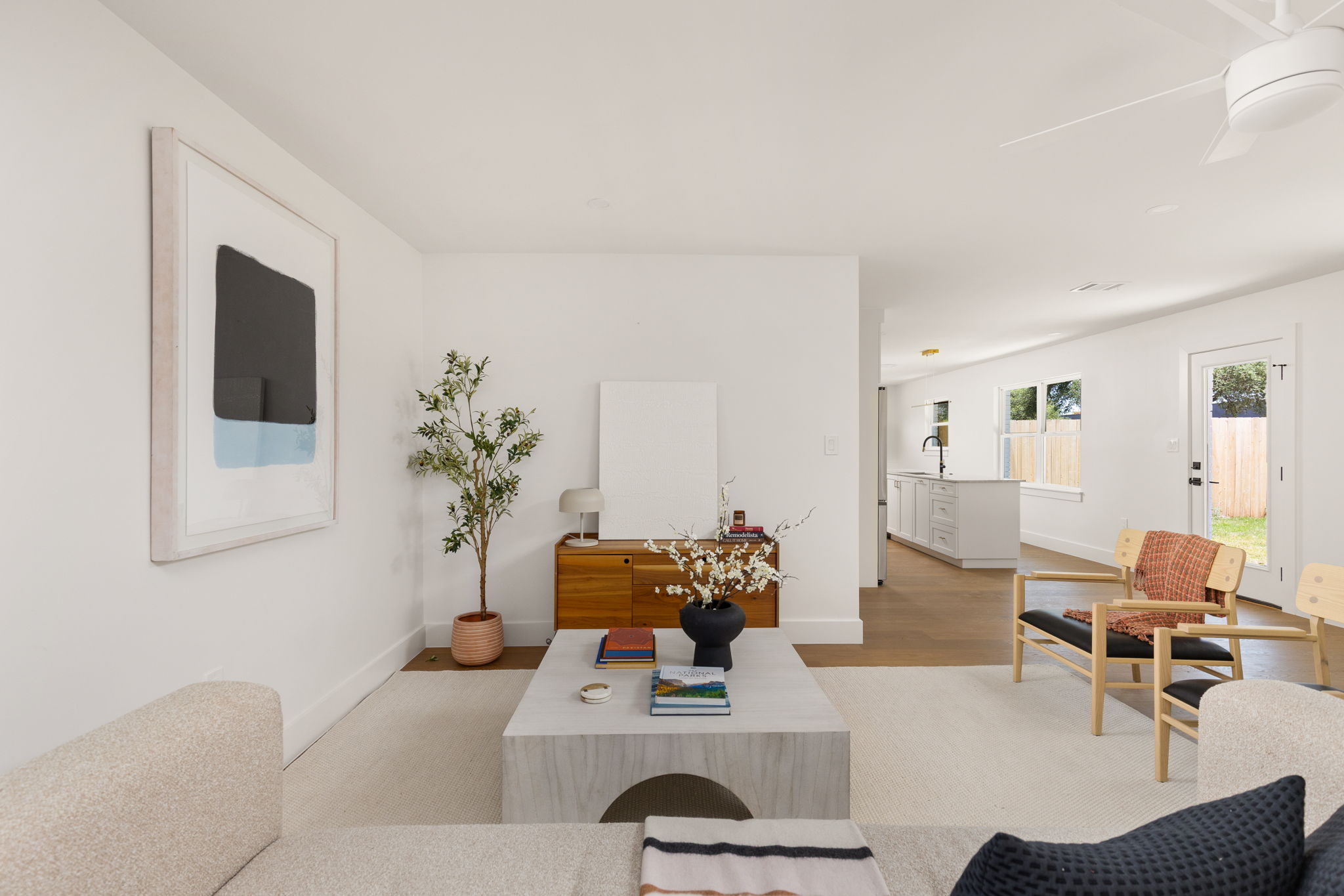 4501 Pack Saddle Pass Austin, TX 78745 - Photo 6 of 37 Living area featuring clean white walls, a white ceiling fan, and light-toned carpeting