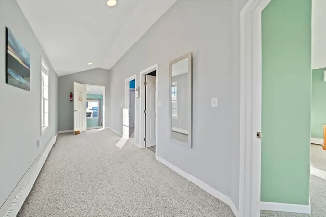 a view of a hallway with wooden shelves