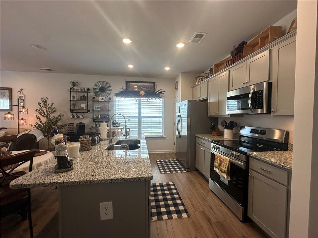 53 Bennett Way Rome, GA 30161 - Photo 37 of 42 a kitchen with granite countertop lots of counter top space a sink a stove and cabinets