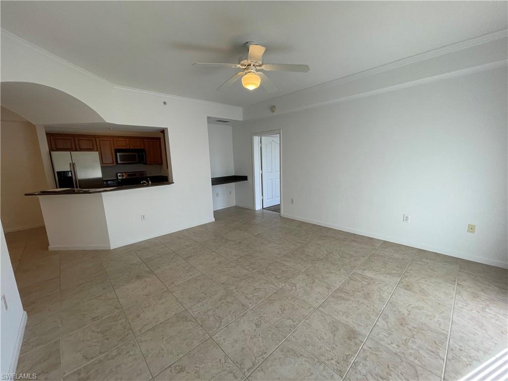12940 Positano Circle, Unit 202 Naples, FL 34105 - Photo 1 of 33 a view of a kitchen with microwave and cabinets