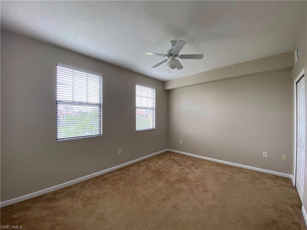 12940 Positano Circle, Unit 202 Naples, FL 34105 - Photo 13 of 33 a view of room with a ceiling fan and window