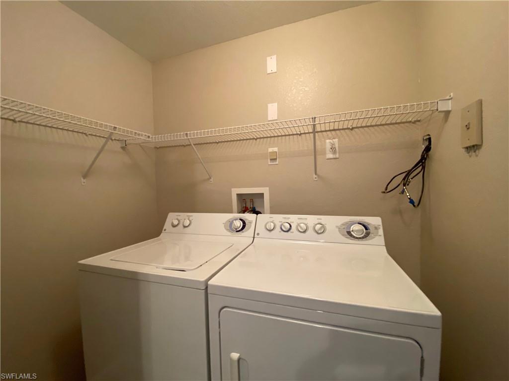 12940 Positano Circle, Unit 202 Naples, FL 34105 - Photo 18 of 33 a utility room with dryer and washer