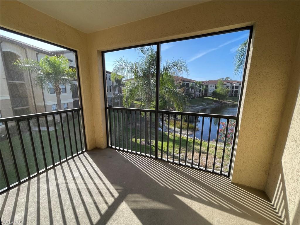 12940 Positano Circle, Unit 202 Naples, FL 34105 - Photo 20 of 33 a view of a balcony with wooden floor