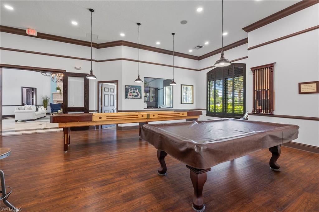 12940 Positano Circle, Unit 202 Naples, FL 34105 - Photo 28 of 33 a living room with furniture pool table and a large window