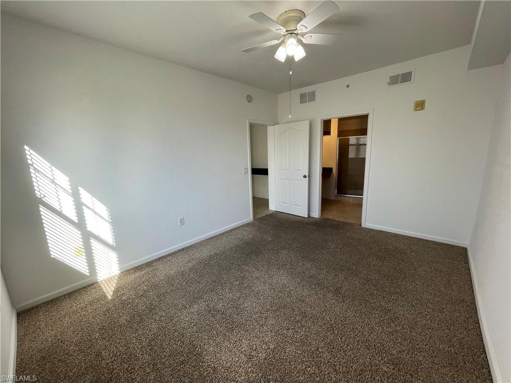 12940 Positano Circle, Unit 202 Naples, FL 34105 - Photo 10 of 33 a view of an empty room with a window