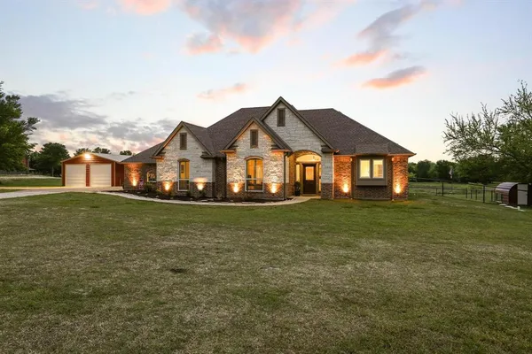 a front view of a house with a garden
