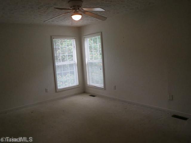 110 Aaron Road Elkin, NC 28621 - Photo 11 of 16 Master Bedroom. Master bedroom is located toward the back of the home and features two corner windows and ceiling fan.