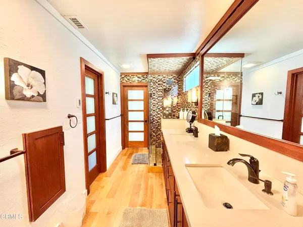 a spacious bathroom with a tub sink and mirror