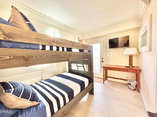 a bedroom with a bed and lamp with the wall