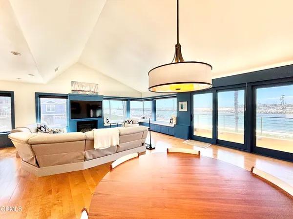 a living room with fireplace furniture and a floor to ceiling window