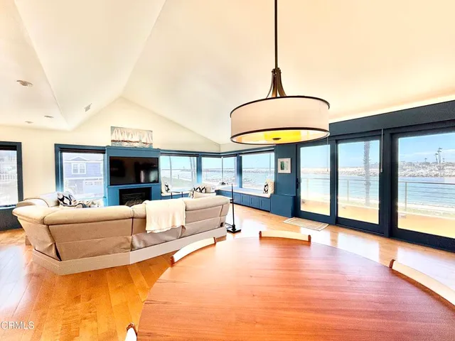 a living room with fireplace furniture and a floor to ceiling window