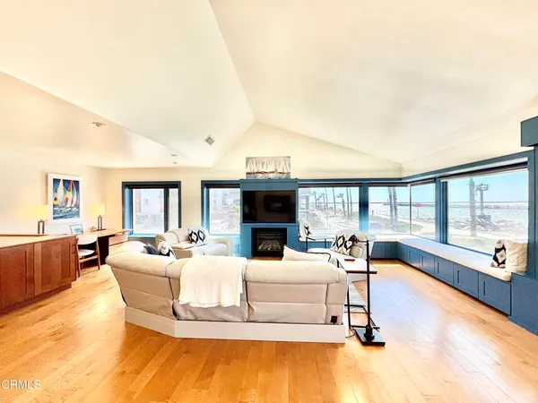 a living room with furniture large window and a fireplace