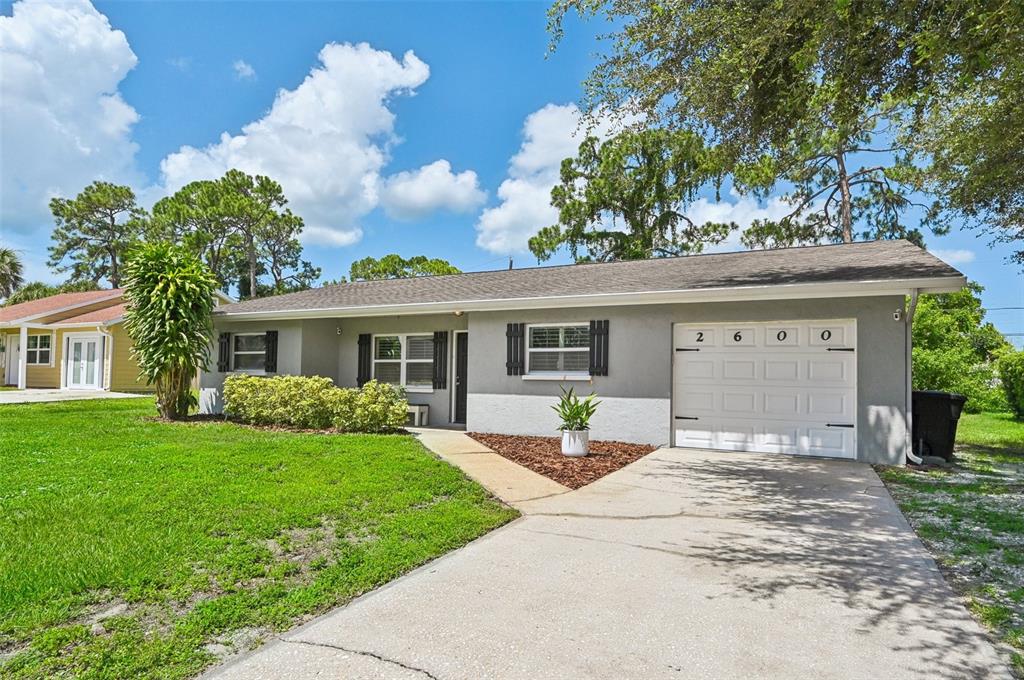 2600 Osage Road Venice, FL 34293 - Photo 1 of 1 a front view of a house with a garden and yard
