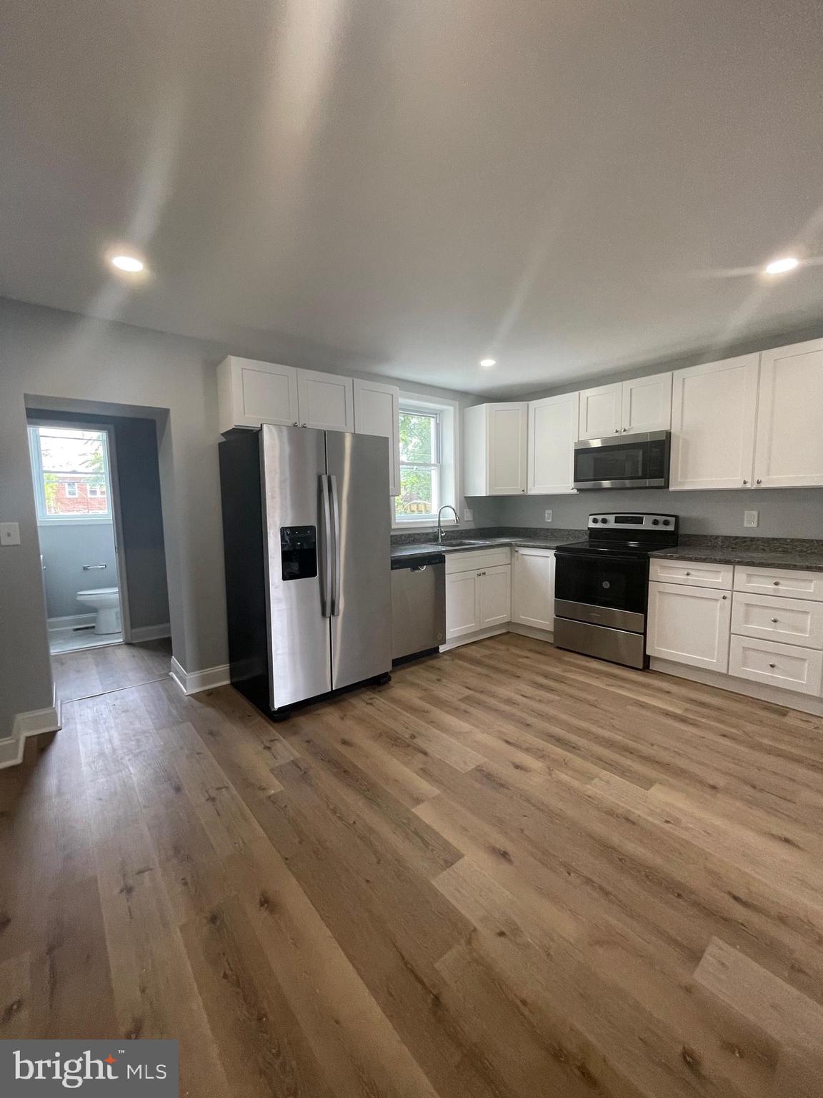 3619 Manchester Avenue Baltimore, MD 21215 - Photo 11 of 33 a large kitchen with stainless steel appliances granite countertop a stove and a refrigerator