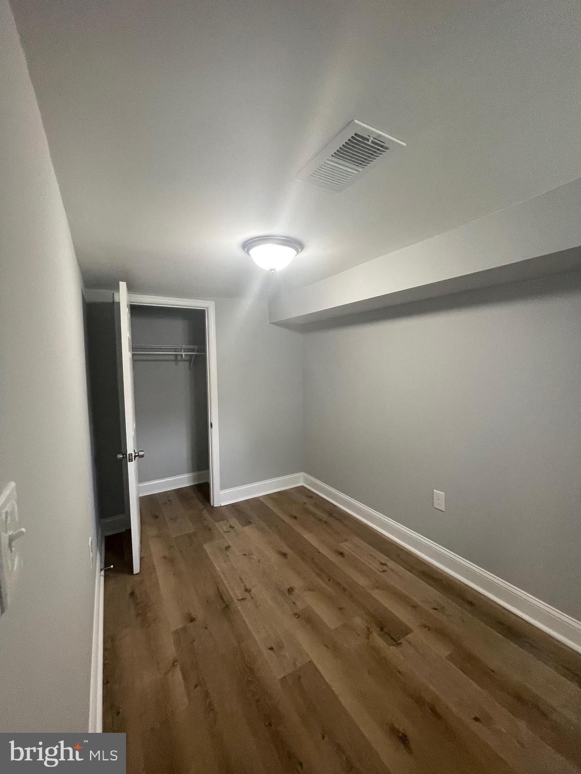 3619 Manchester Avenue Baltimore, MD 21215 - Photo 18 of 33 a view of an empty room with wooden floor and a window