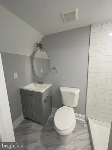 a bathroom with a toilet and a bathtub