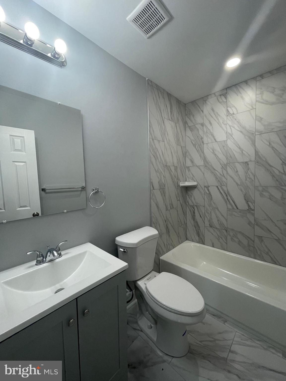 3619 Manchester Avenue Baltimore, MD 21215 - Photo 25 of 33 a bathroom with a toilet a sink a mirror and bathtub