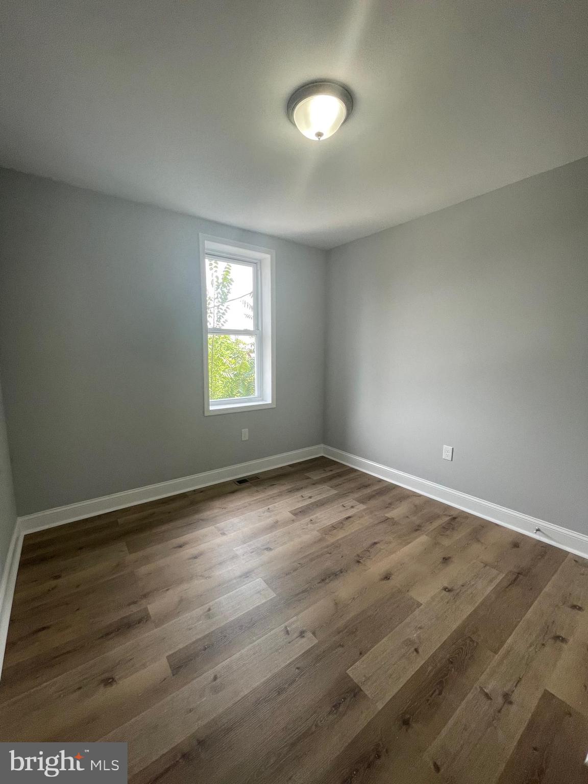 3619 Manchester Avenue Baltimore, MD 21215 - Photo 26 of 33 an empty room with wooden floor and windows