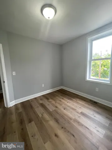 a view of an empty room and wooden floor
