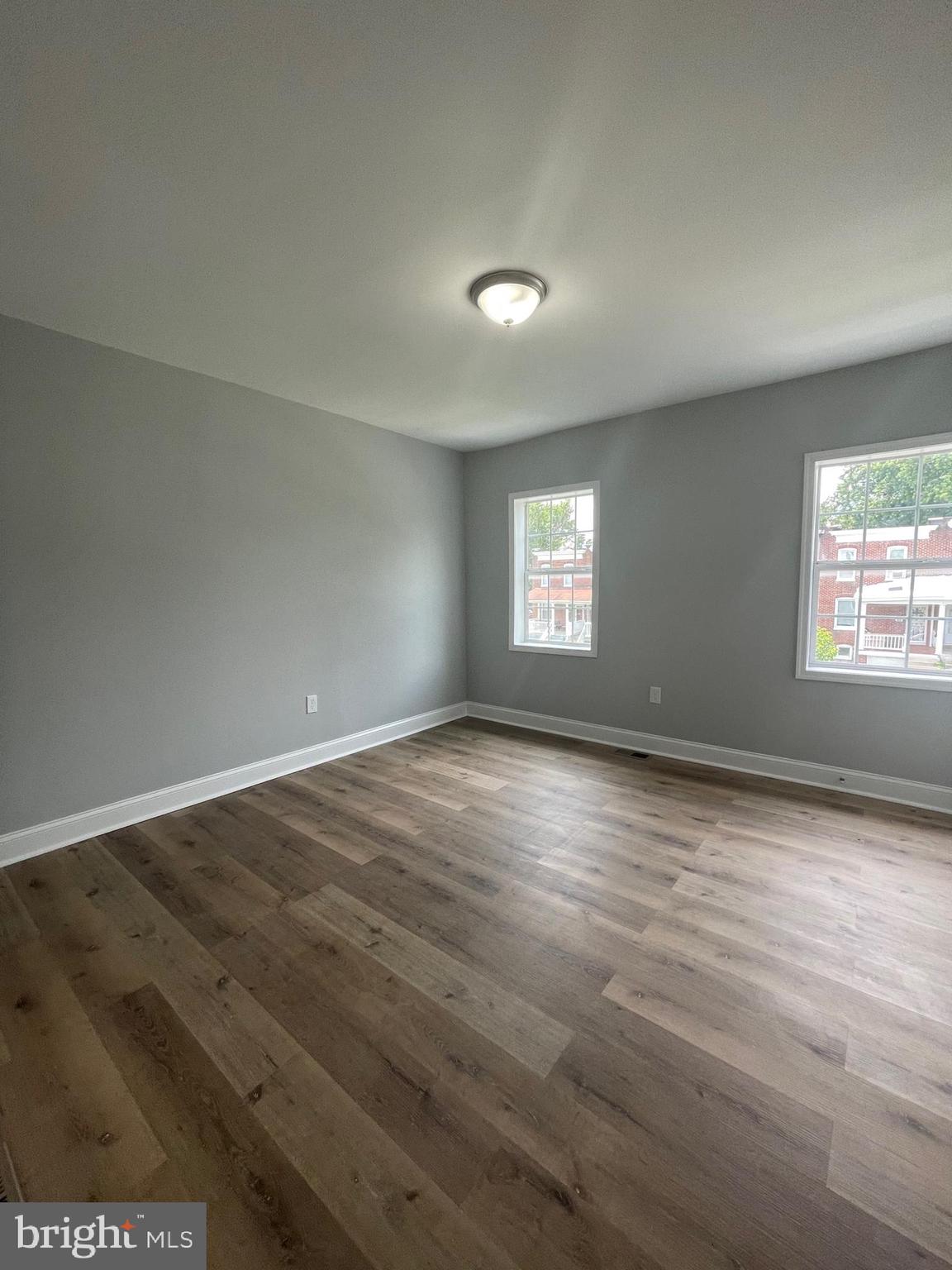 3619 Manchester Avenue Baltimore, MD 21215 - Photo 30 of 33 an empty room with wooden floor and windows