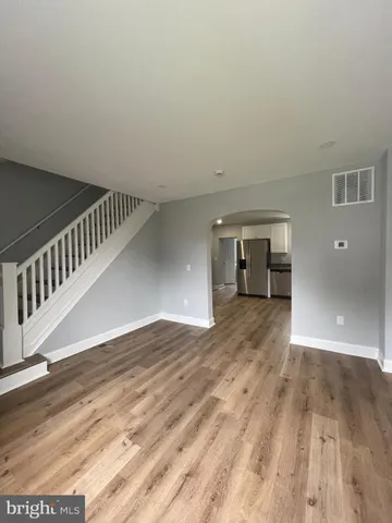 a view of an empty room and wooden floor
