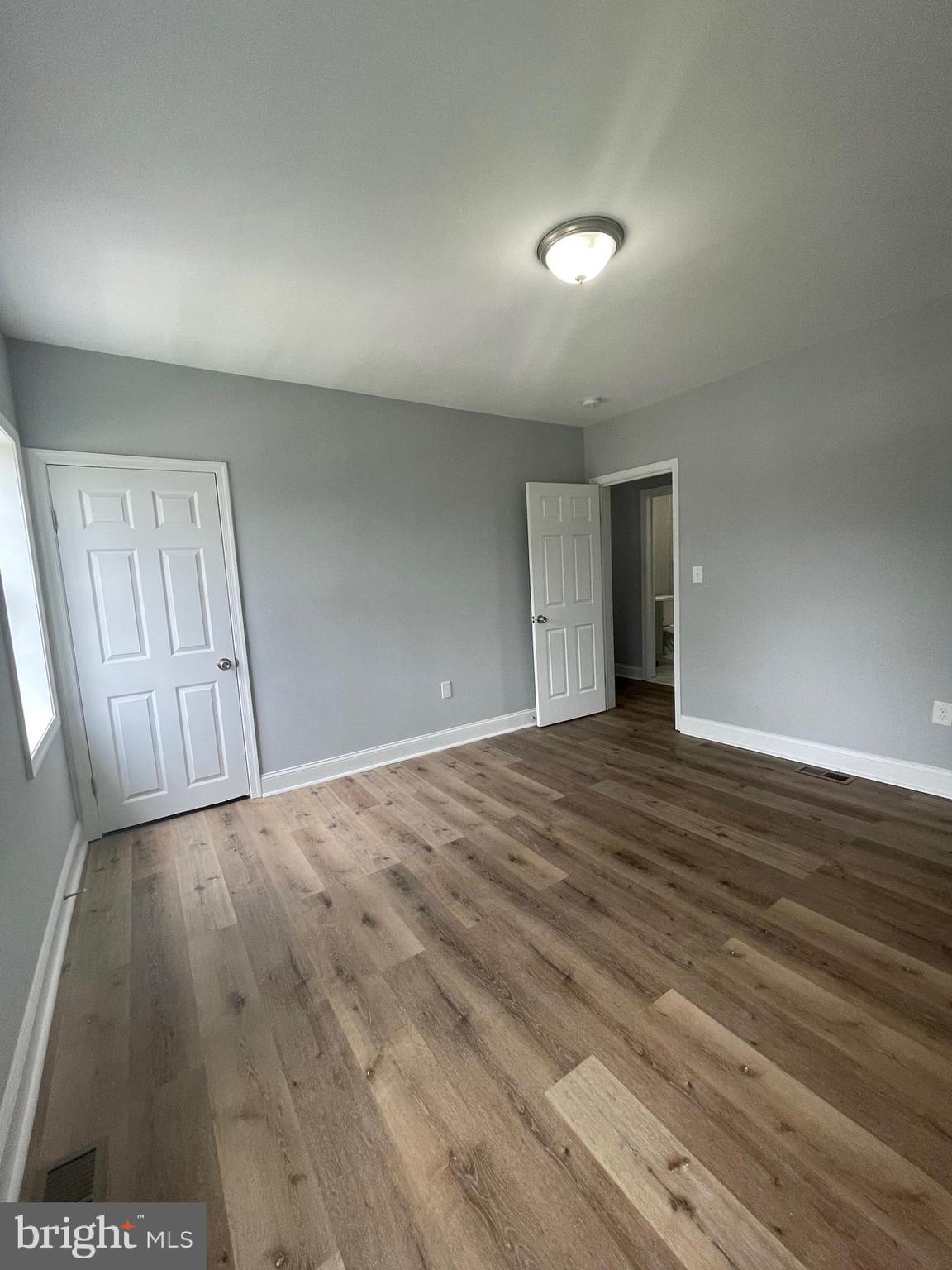 3619 Manchester Avenue Baltimore, MD 21215 - Photo 32 of 33 wooden floor in an empty room with a window