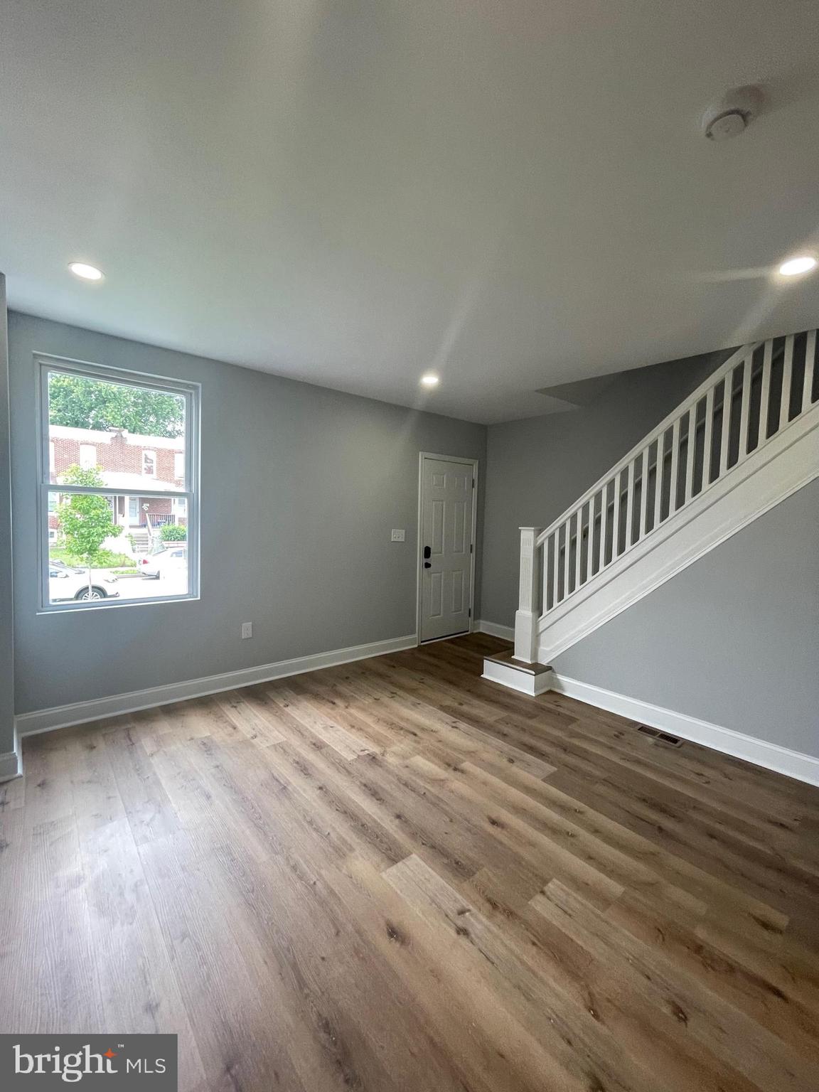 3619 Manchester Avenue Baltimore, MD 21215 - Photo 6 of 33 a view of an empty room with wooden floor and a window