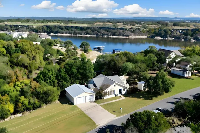 an aerial view of a house with a lake view
