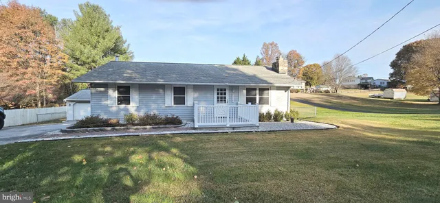 a front view of a house with a yard table and chairs