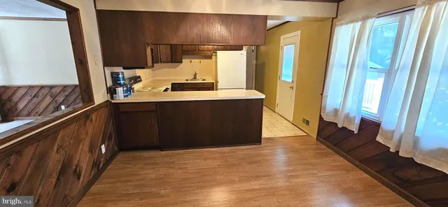 a kitchen with stainless steel appliances a sink stove and cabinets